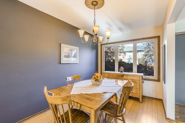 dining room with a chandelier and light hardwood / wood-style flooring