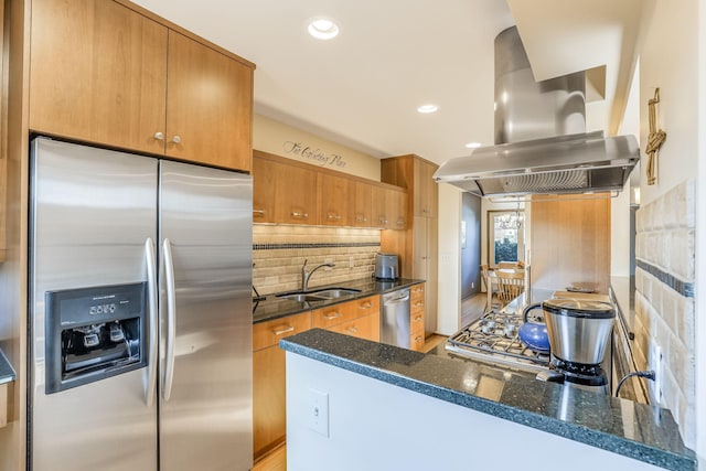 kitchen with sink, backsplash, stainless steel appliances, island exhaust hood, and dark stone counters