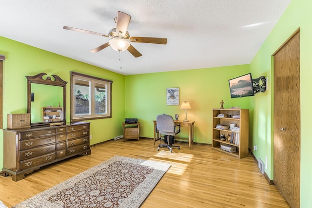 office with ceiling fan, a textured ceiling, and light hardwood / wood-style flooring