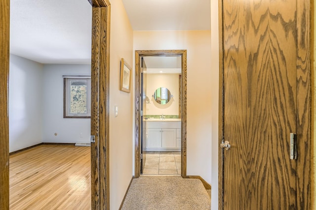 hall featuring sink and light hardwood / wood-style flooring