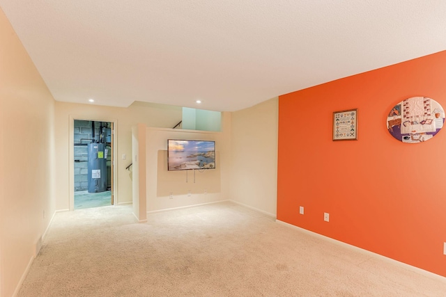 carpeted spare room featuring electric water heater