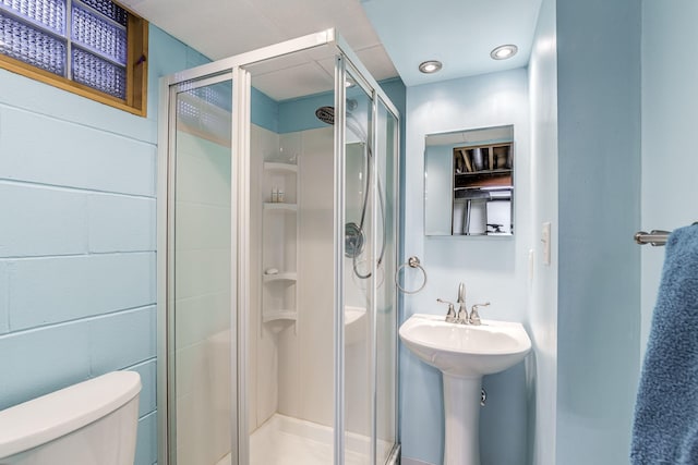 bathroom featuring toilet, sink, and walk in shower