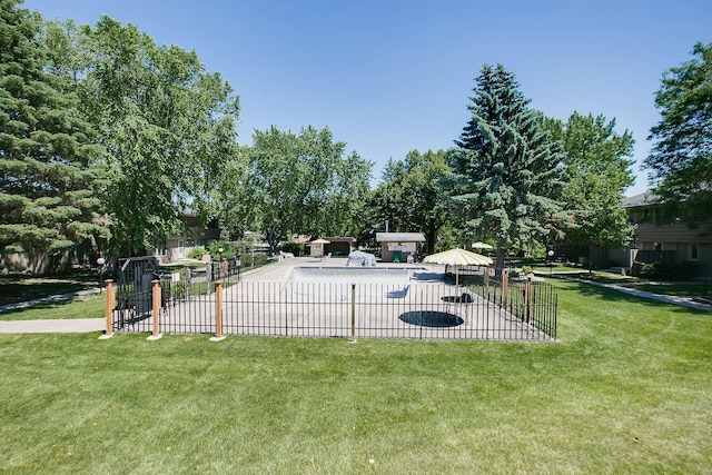 view of pool featuring a lawn and a patio