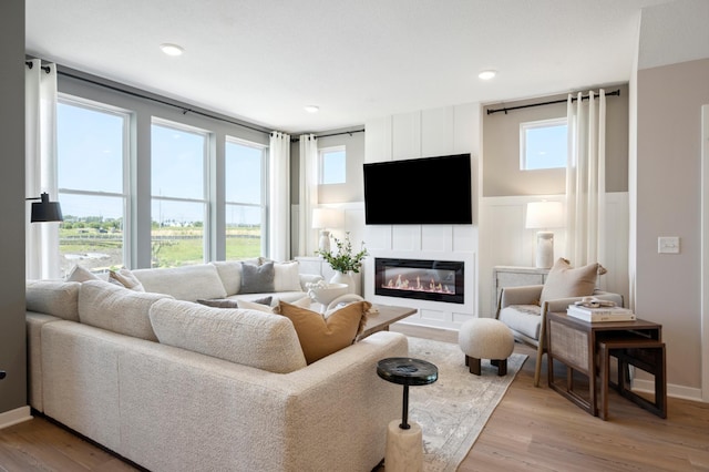 living room featuring light hardwood / wood-style flooring and plenty of natural light