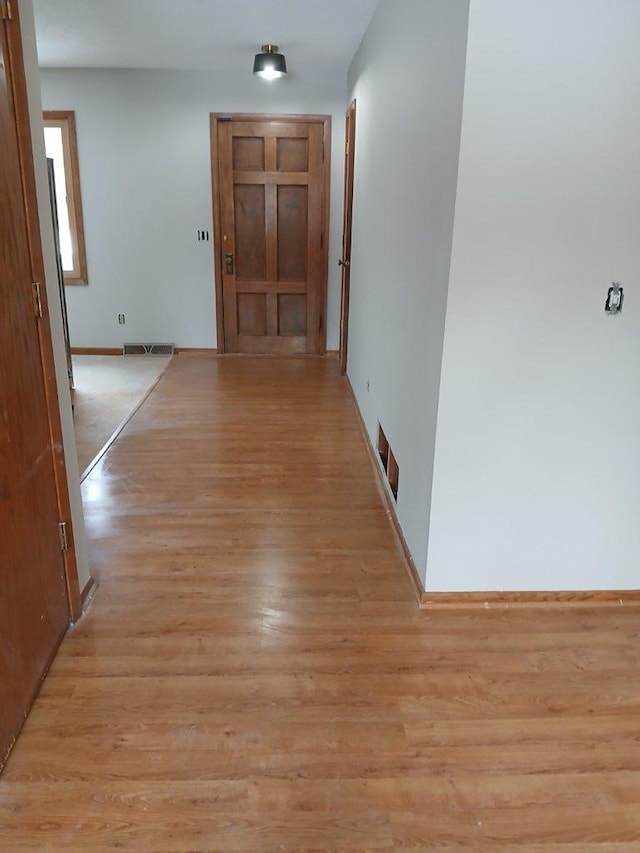 corridor with light wood-type flooring