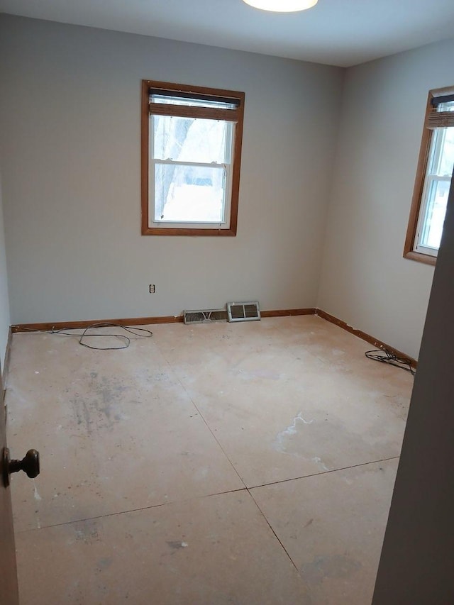 empty room with visible vents and baseboards