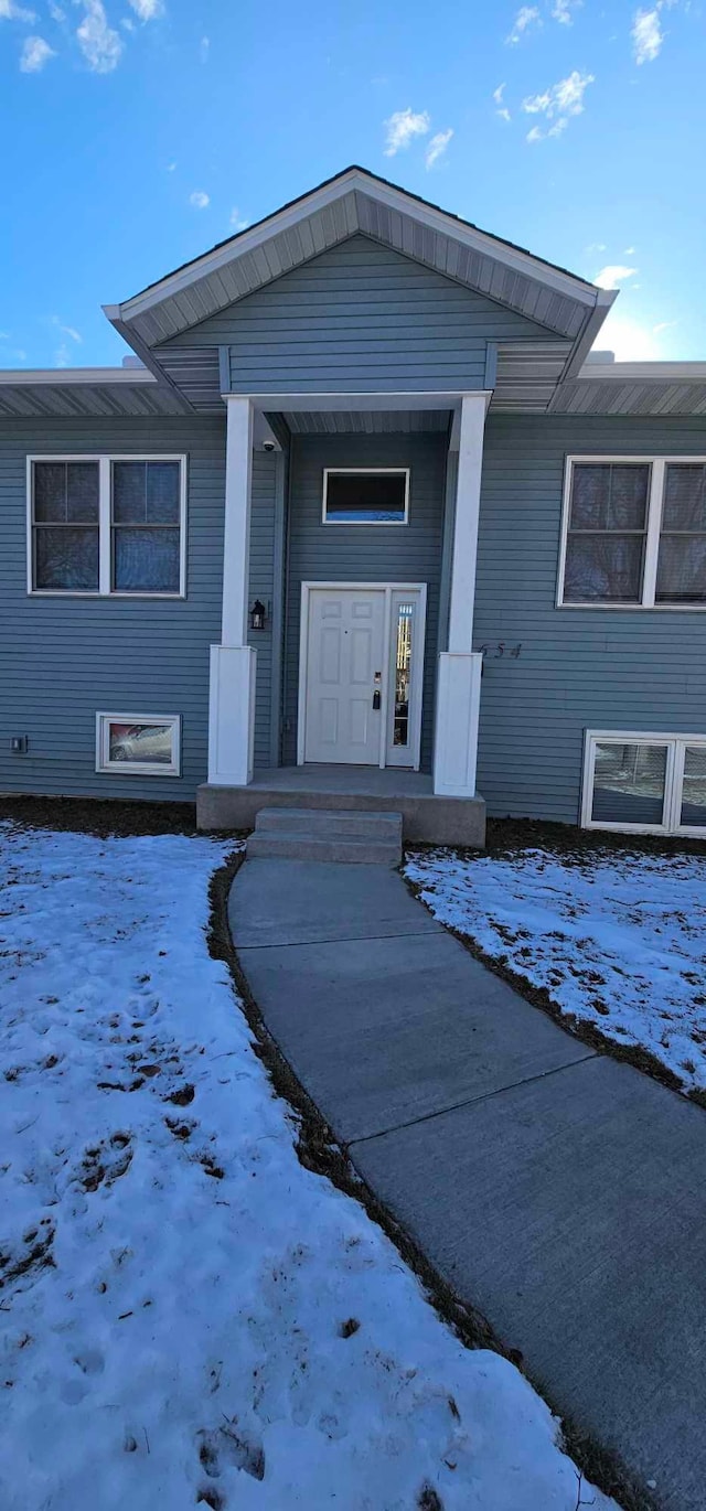 view of snow covered property entrance