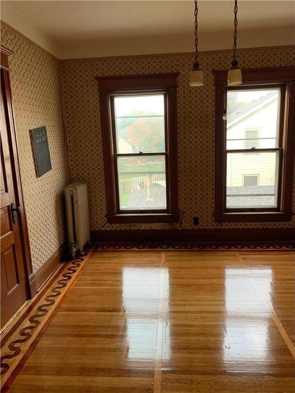 empty room featuring hardwood / wood-style flooring and radiator