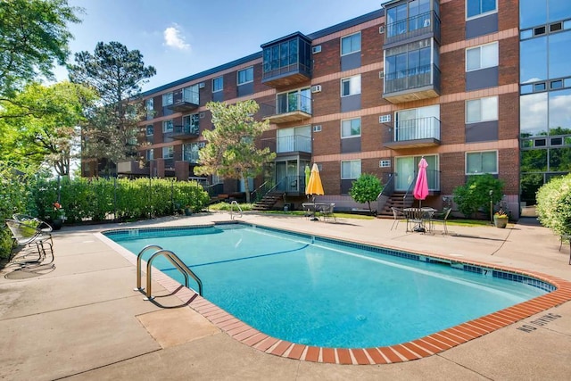 view of swimming pool featuring a patio