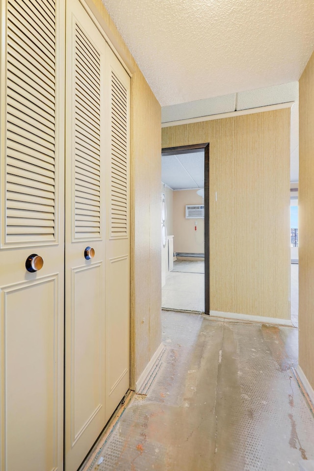 hallway featuring concrete flooring and a textured ceiling