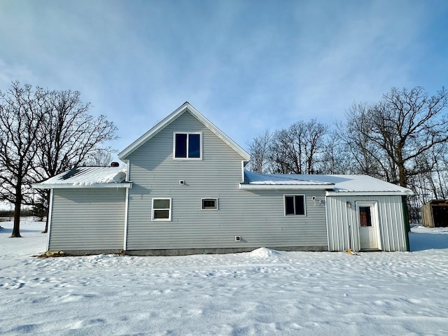 view of snow covered rear of property