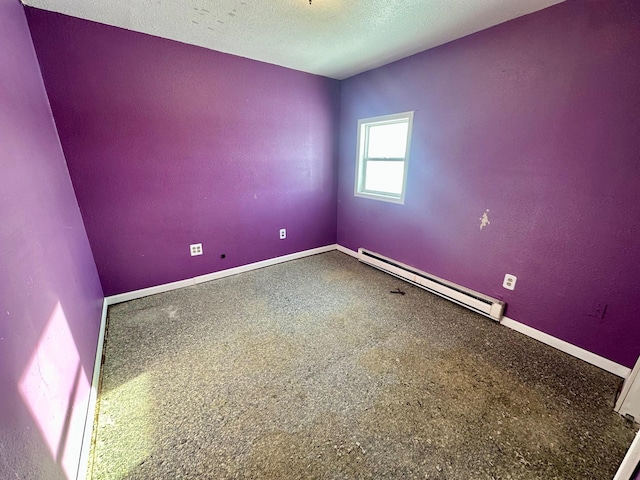 unfurnished room with a textured ceiling and a baseboard radiator