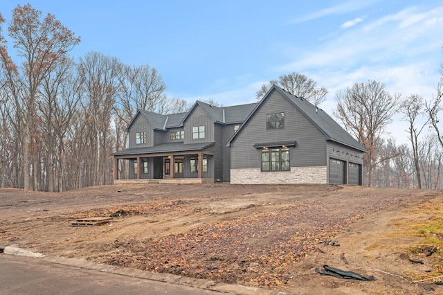 view of front of home featuring covered porch and a garage