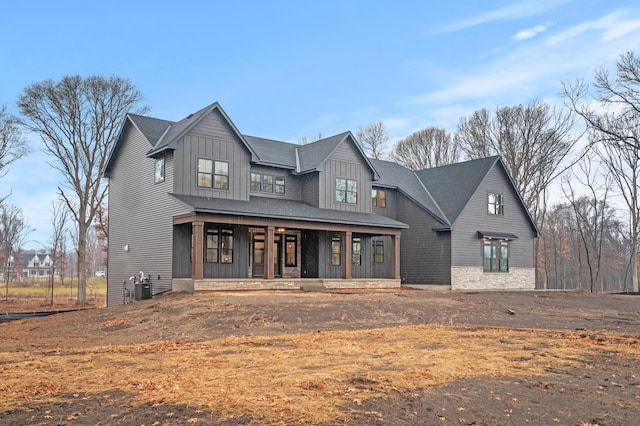 modern farmhouse style home featuring covered porch and central AC