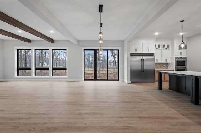 kitchen featuring hanging light fixtures, decorative backsplash, beam ceiling, white cabinetry, and stainless steel appliances