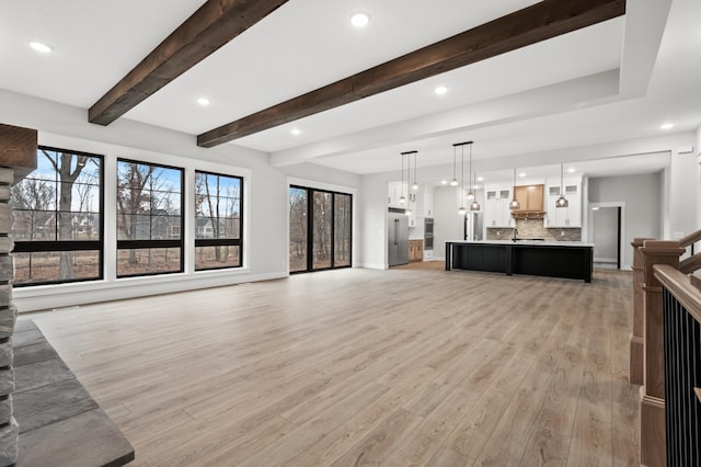 living room with beam ceiling and light hardwood / wood-style flooring