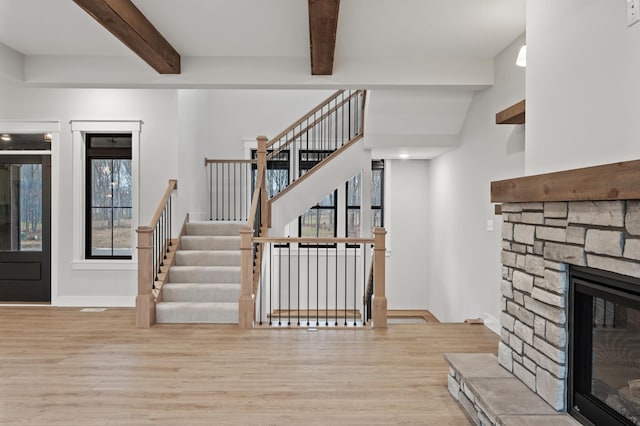 interior space featuring a fireplace, hardwood / wood-style flooring, and a healthy amount of sunlight