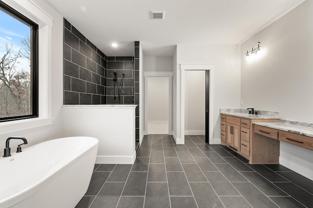 bathroom featuring tile patterned flooring, vanity, plenty of natural light, and plus walk in shower