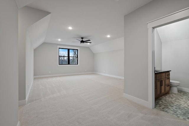 bonus room featuring ceiling fan, lofted ceiling, and light carpet