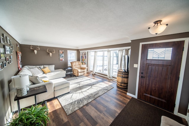 living room with hardwood / wood-style flooring, a textured ceiling, and a wealth of natural light