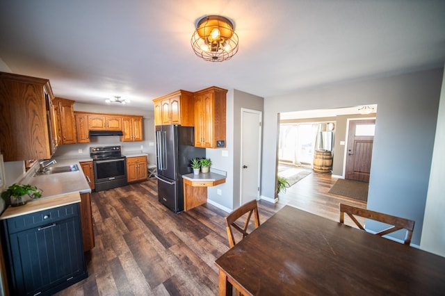 kitchen with electric range, black fridge, sink, and dark wood-type flooring