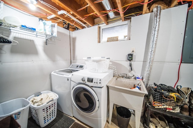 laundry area featuring washing machine and clothes dryer and sink