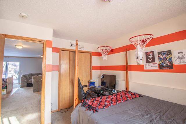 carpeted bedroom featuring a textured ceiling and a closet