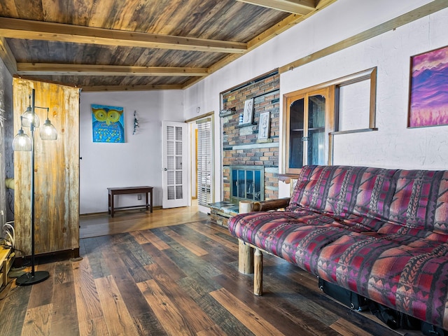 living room with a fireplace, beamed ceiling, dark hardwood / wood-style floors, and wooden ceiling