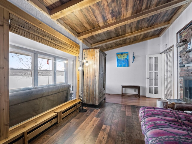 living room with lofted ceiling with beams, dark hardwood / wood-style flooring, wooden ceiling, and a brick fireplace