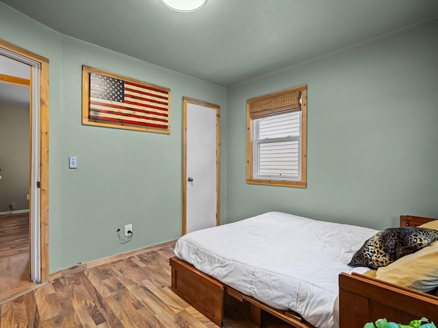 bedroom with wood-type flooring