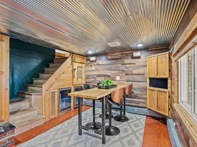 dining space with wood walls and wood ceiling