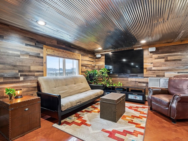 living room with wooden ceiling and wooden walls