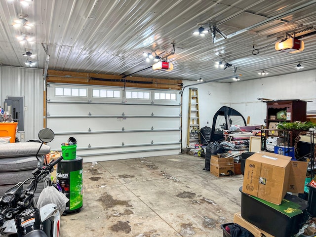 garage with electric panel and a garage door opener