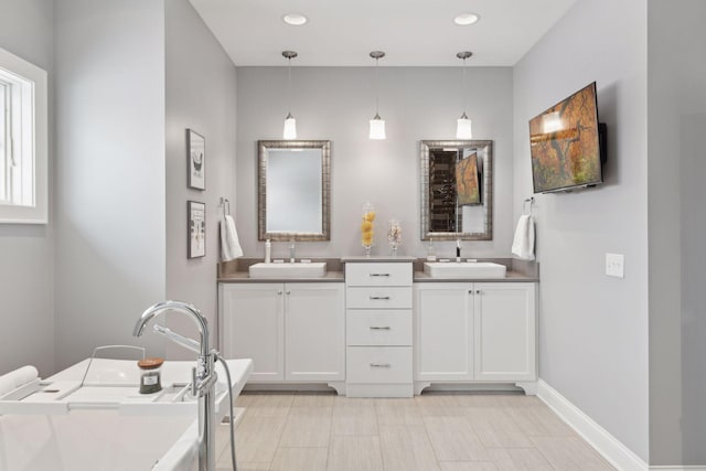 bathroom featuring vanity and a bath