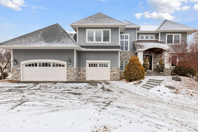 view of front facade featuring a garage, stone siding, and roof with shingles