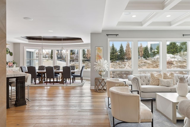 living room featuring a notable chandelier, coffered ceiling, beamed ceiling, and light hardwood / wood-style flooring