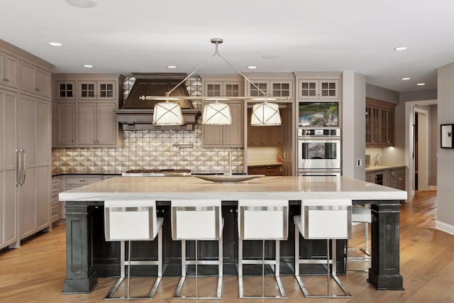 kitchen featuring a kitchen bar, sink, and a large island