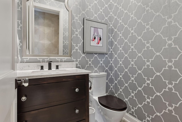 bathroom featuring toilet and vanity