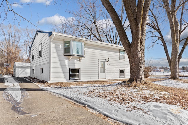 split foyer home with a garage and an outbuilding