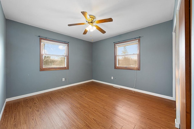 unfurnished room with ceiling fan and hardwood / wood-style flooring