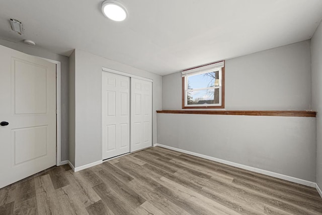 unfurnished bedroom with light hardwood / wood-style floors and a closet