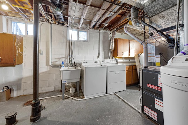 basement with washer and dryer, sink, and a healthy amount of sunlight