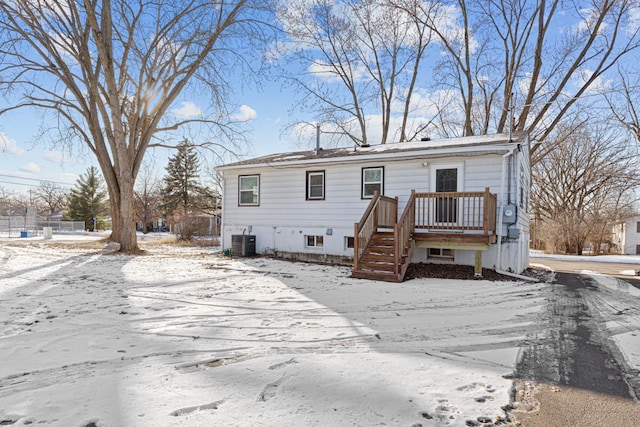 view of front of property featuring a wooden deck and central AC unit