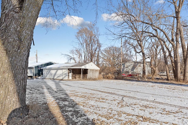 snowy yard featuring an outdoor structure