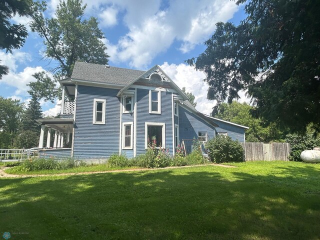 rear view of house with a lawn