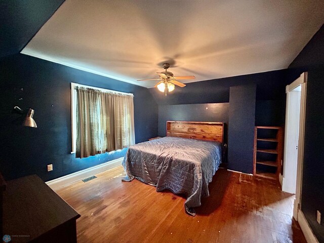 bedroom featuring hardwood / wood-style floors, ceiling fan, and vaulted ceiling