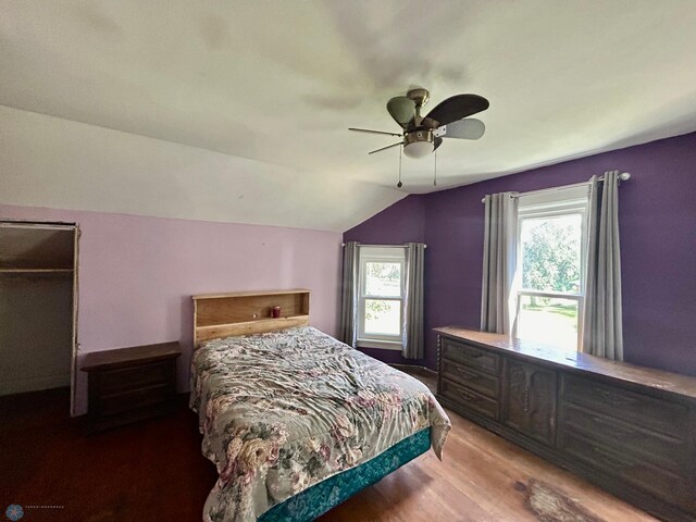 bedroom with hardwood / wood-style flooring, ceiling fan, and lofted ceiling