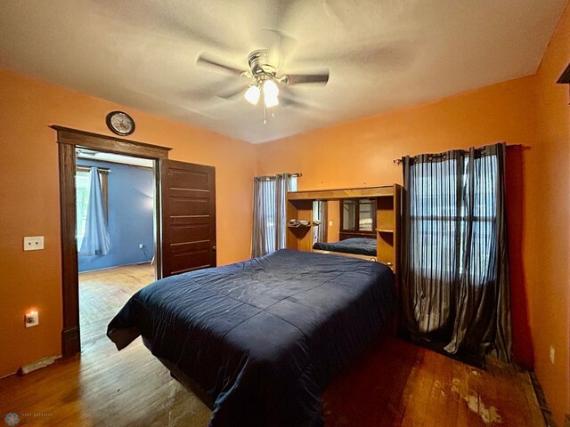 bedroom with light hardwood / wood-style flooring and ceiling fan