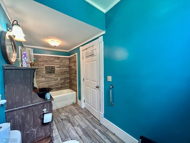 bathroom with toilet, shower / tub combo with curtain, and crown molding