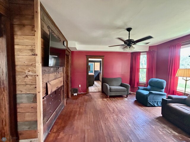 living room with hardwood / wood-style floors and ceiling fan